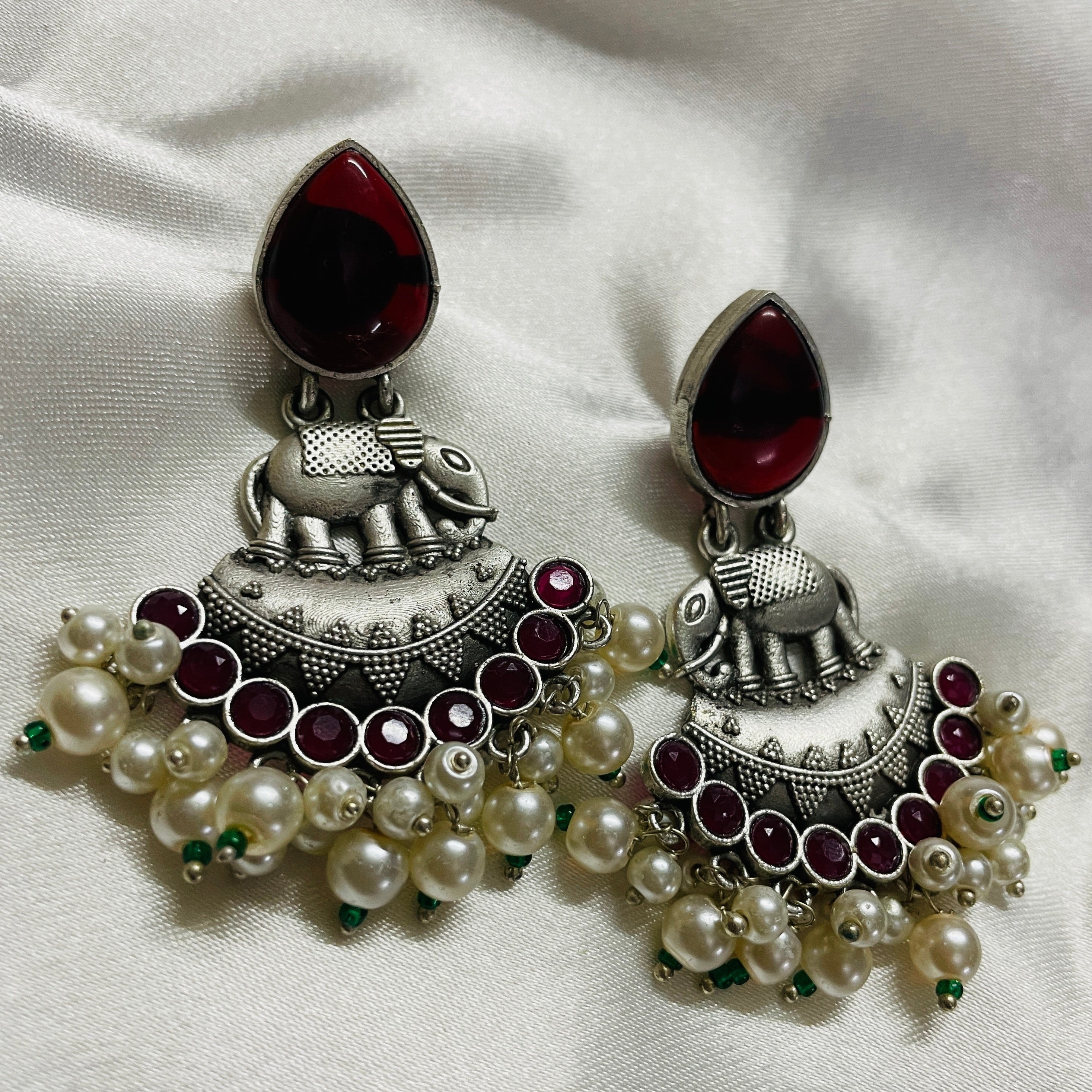 Vibrant Veils Elephant-shaped charm, A cluster of green beads and white pearls dangling Earing